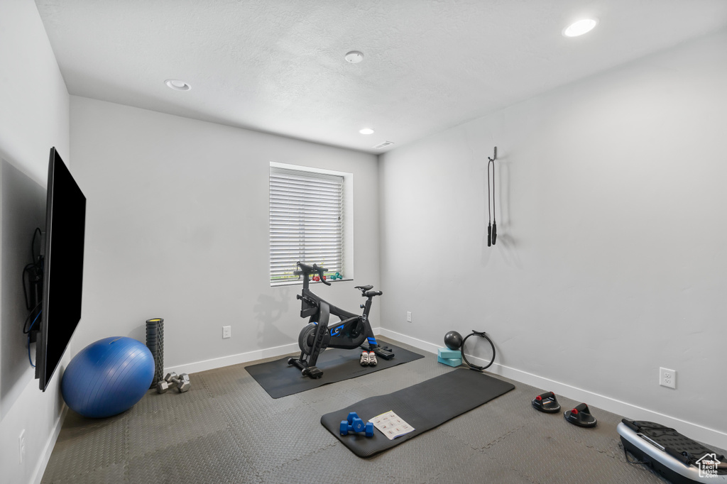 Workout room featuring baseboards and recessed lighting