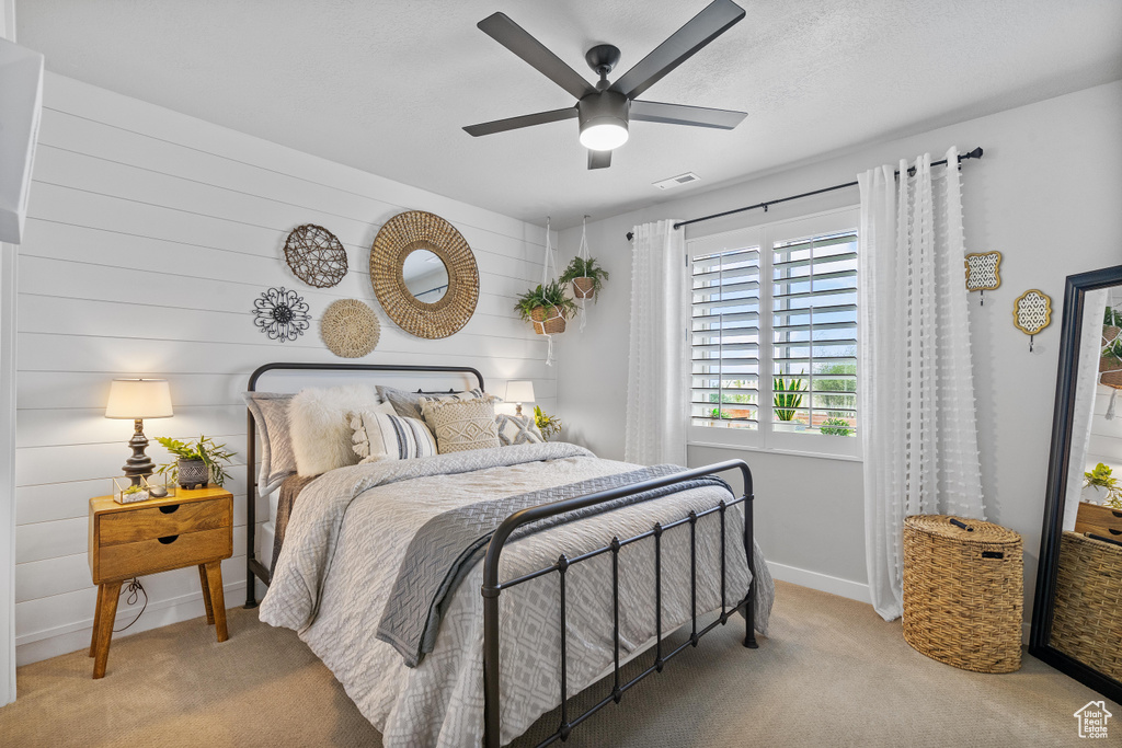 Carpeted bedroom featuring baseboards and a ceiling fan