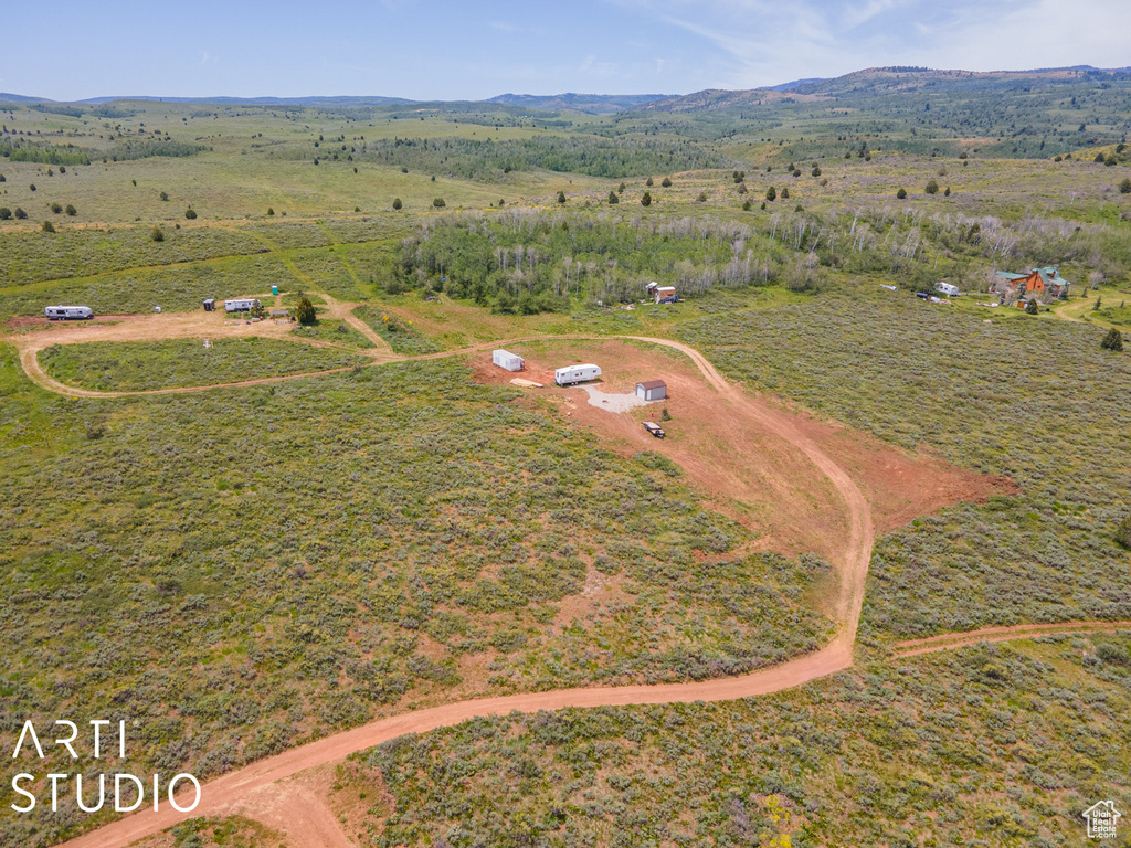 Aerial overview of property's location with rural landscape and a mountain backdrop