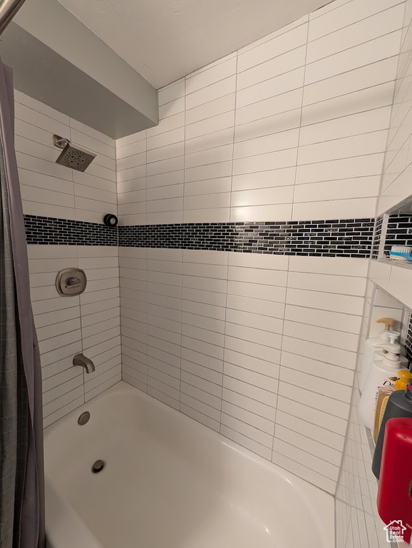 Full bath featuring shower / bath combo with shower curtain