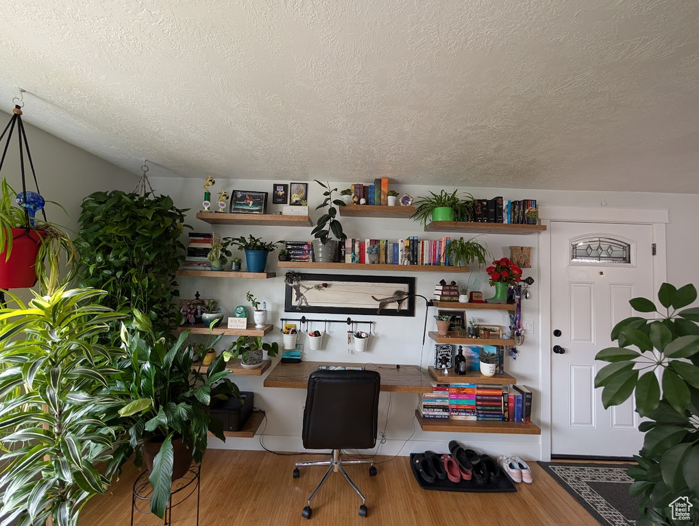 Office featuring a textured ceiling and wood finished floors