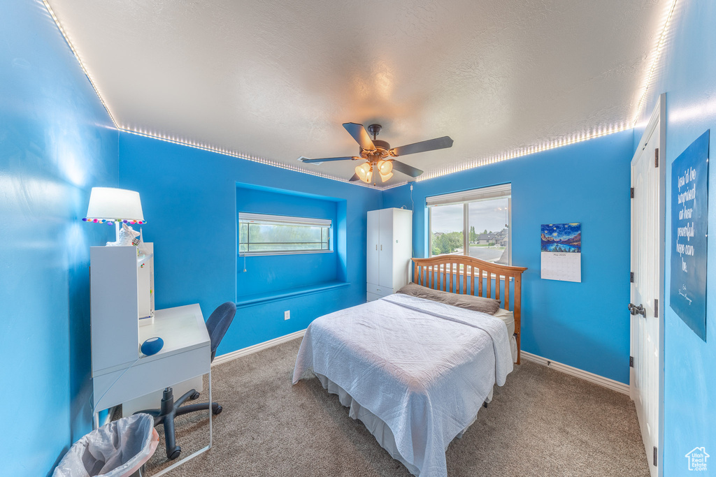Bedroom with carpet flooring, ceiling fan, and baseboards