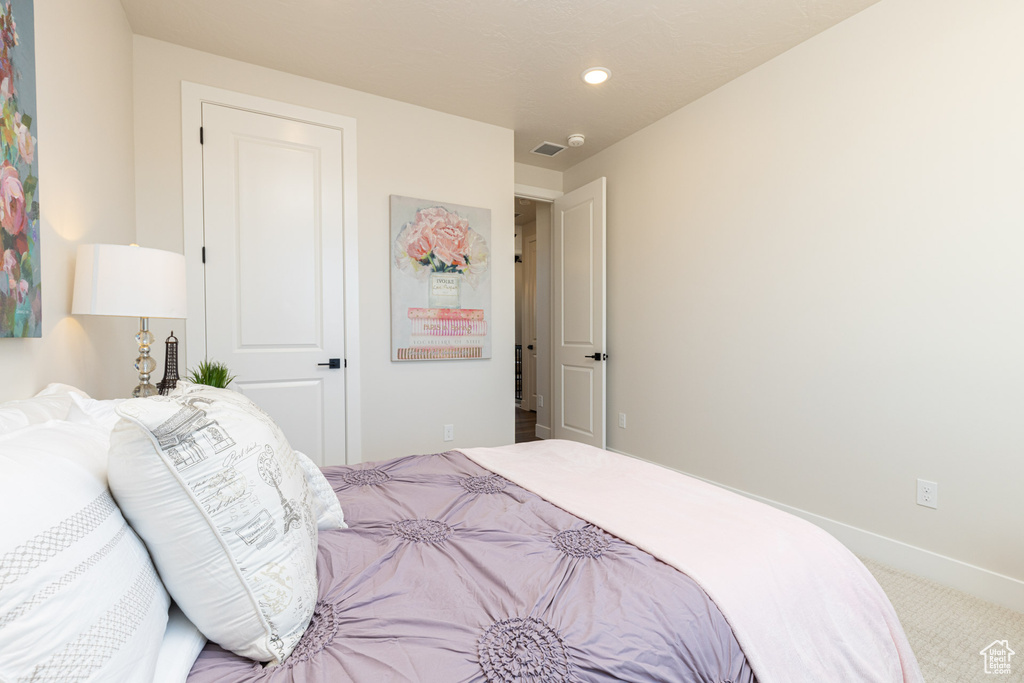 Carpeted bedroom with baseboards and recessed lighting