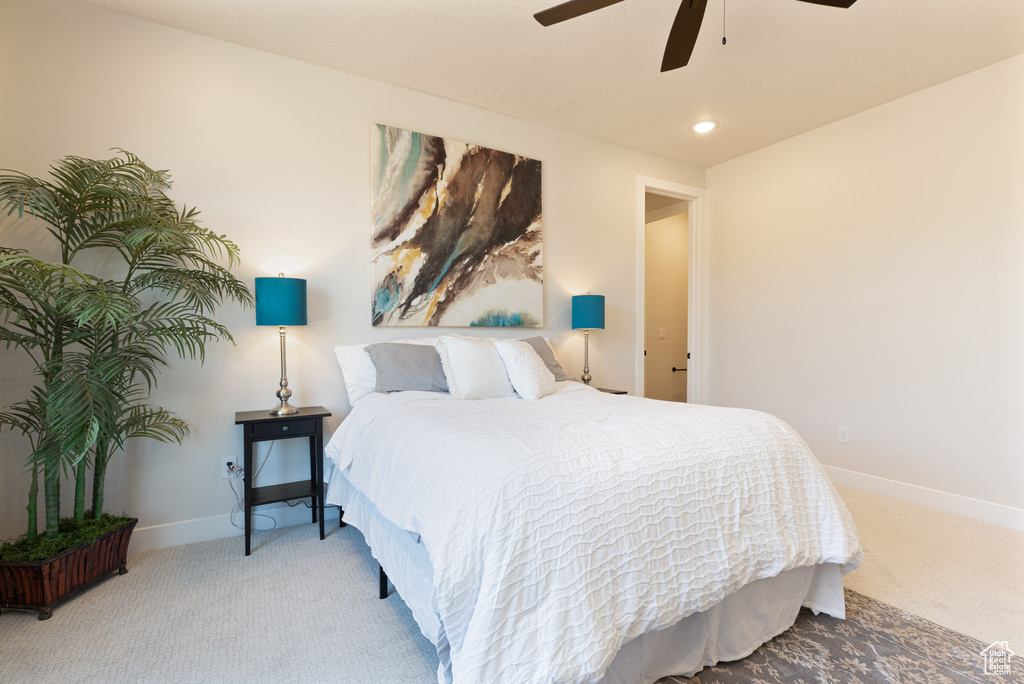 Carpeted bedroom featuring baseboards, ceiling fan, and recessed lighting