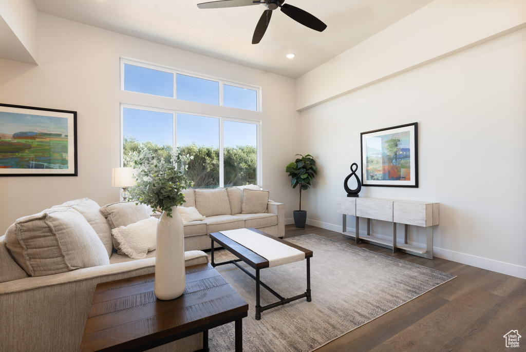 Living room featuring baseboards, wood finished floors, ceiling fan, and recessed lighting