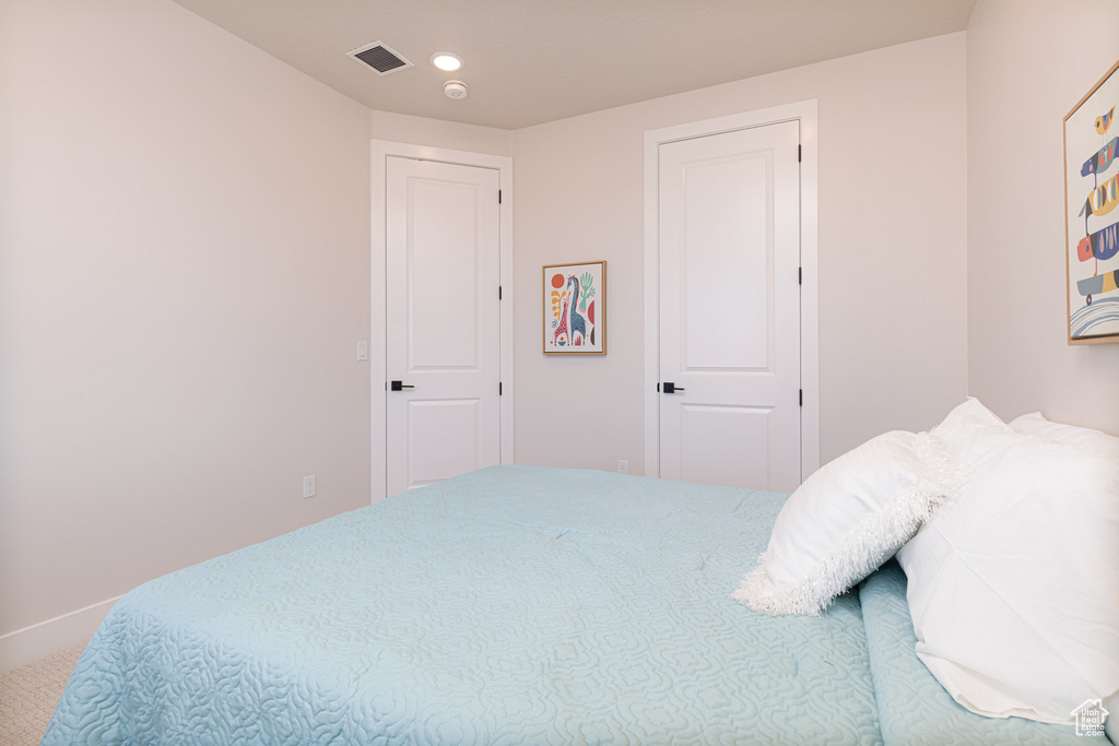 Bedroom with carpet, baseboards, and recessed lighting