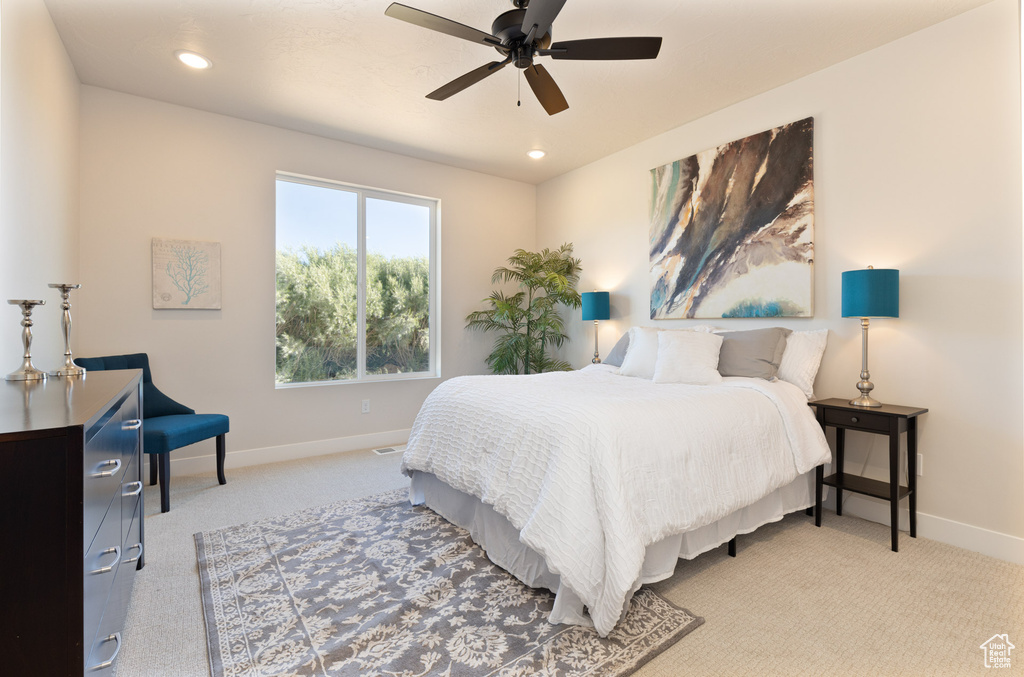 Bedroom featuring baseboards, light carpet, recessed lighting, and ceiling fan