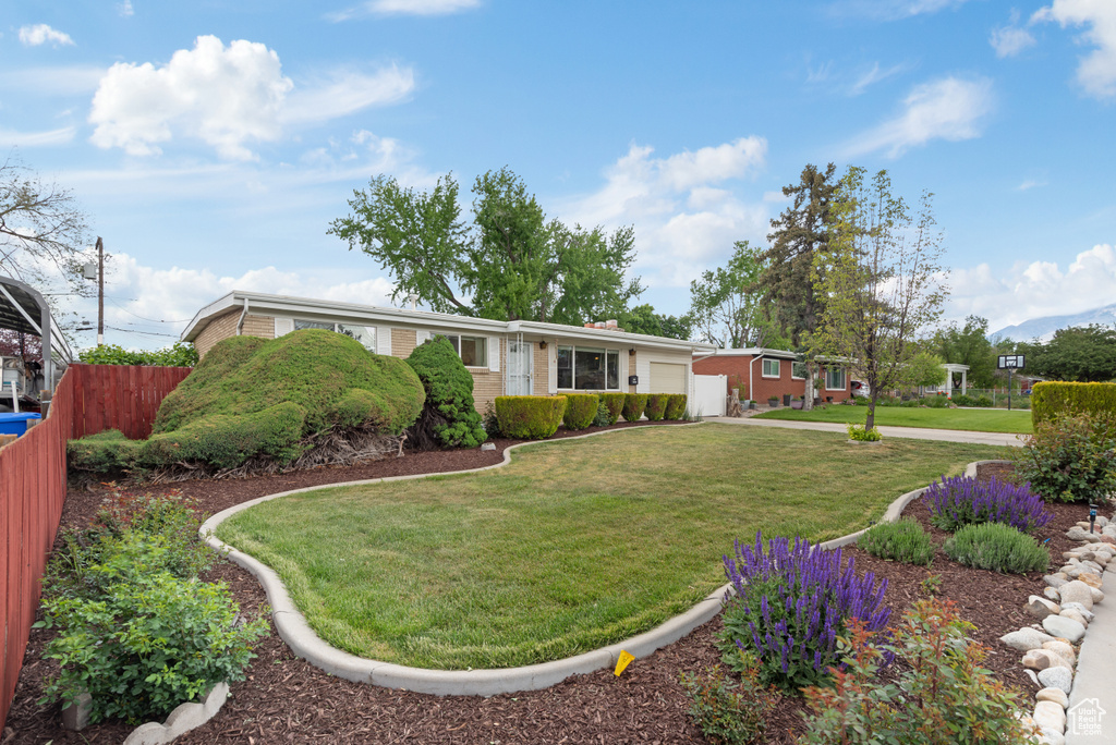 Ranch-style home featuring a garage, brick siding, and concrete driveway