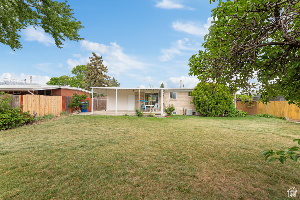 Rear view of property featuring a patio and brick siding