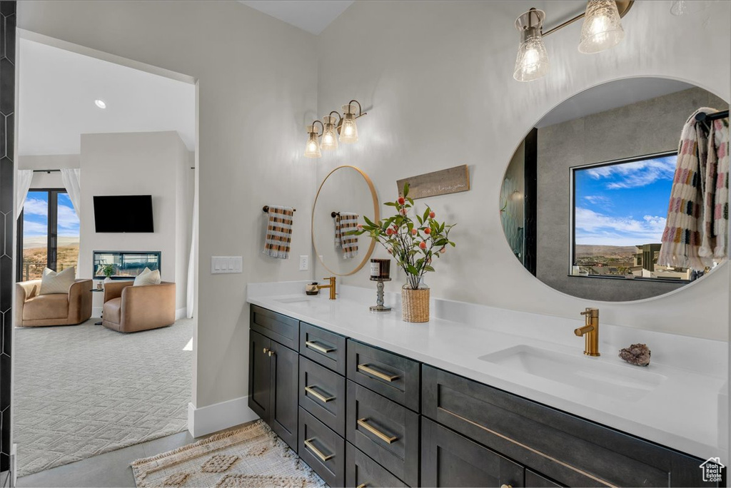 Full bathroom with double vanity and baseboards