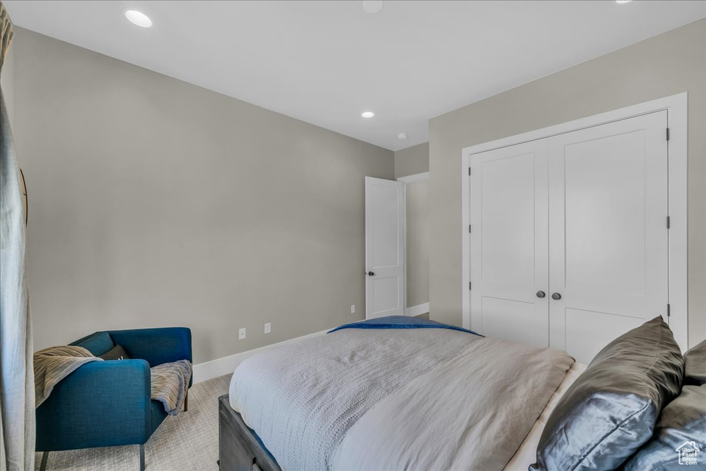 Carpeted bedroom featuring a closet, recessed lighting, and baseboards