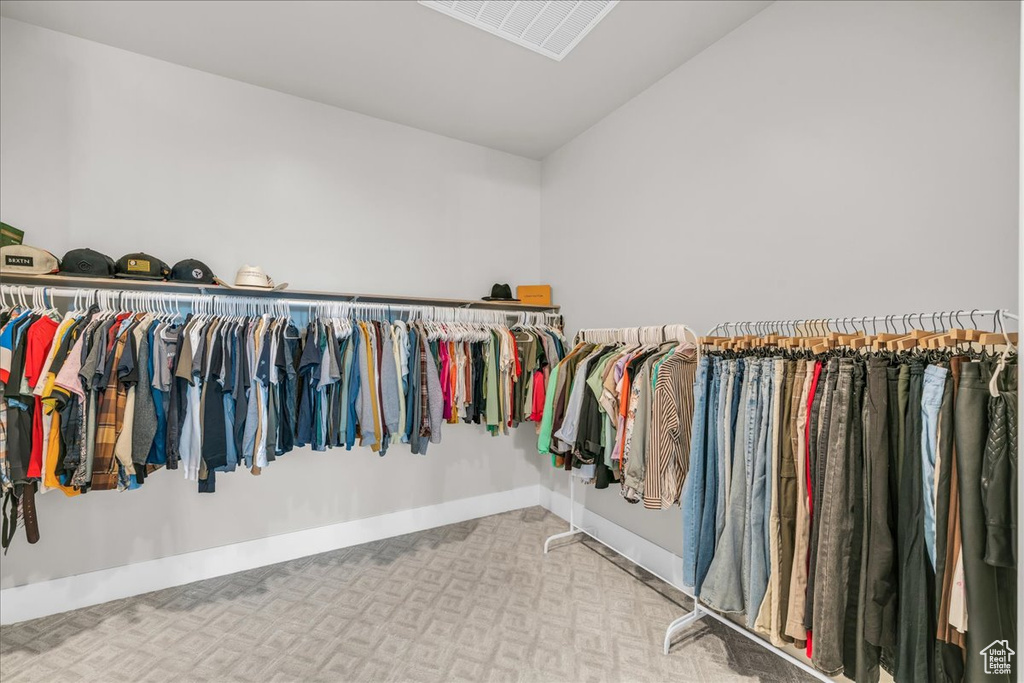 Spacious closet with carpet floors and vaulted ceiling