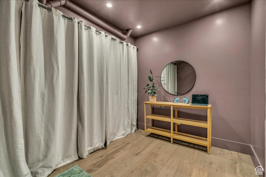 Full bathroom featuring wood finished floors, recessed lighting, vanity, and curtained shower