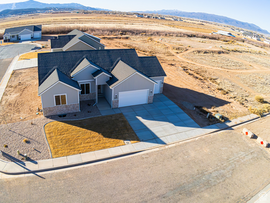 Aerial view of property and surrounding area with mountains