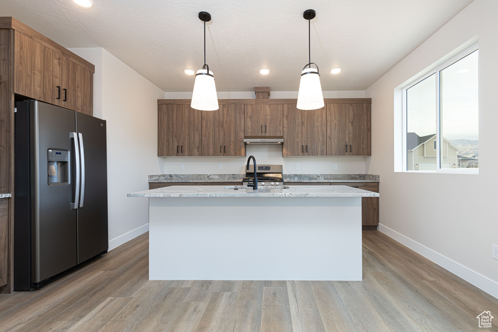 Kitchen featuring stainless steel appliances, a sink, baseboards, light wood-type flooring, and recessed lighting