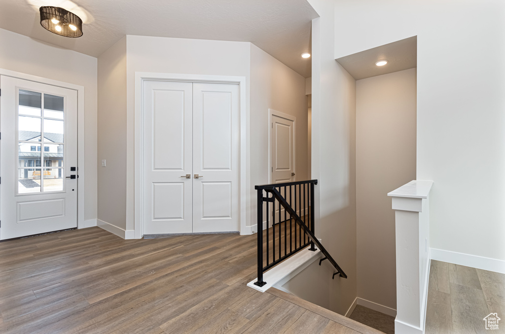 Entryway with wood finished floors, baseboards, and recessed lighting
