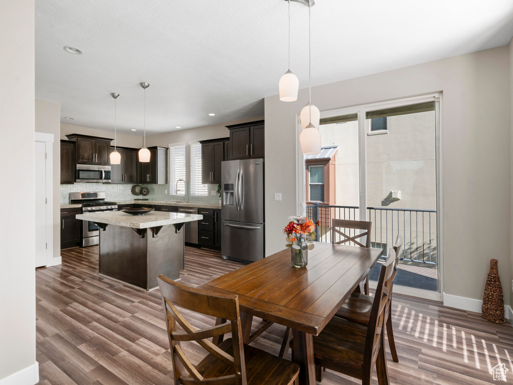 Dining room with dark wood-style floors and baseboards