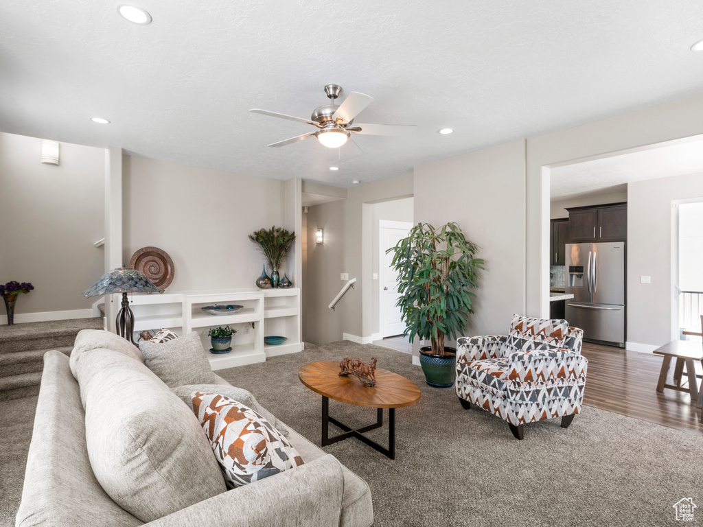 Living area featuring carpet, a ceiling fan, recessed lighting, and baseboards