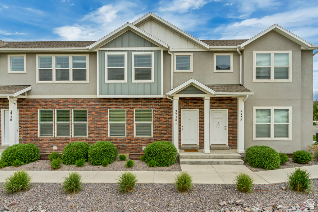 Townhome / multi-family property with board and batten siding and stucco siding