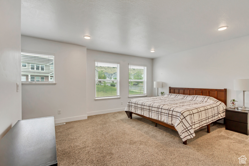 Bedroom with light carpet, baseboards, and recessed lighting