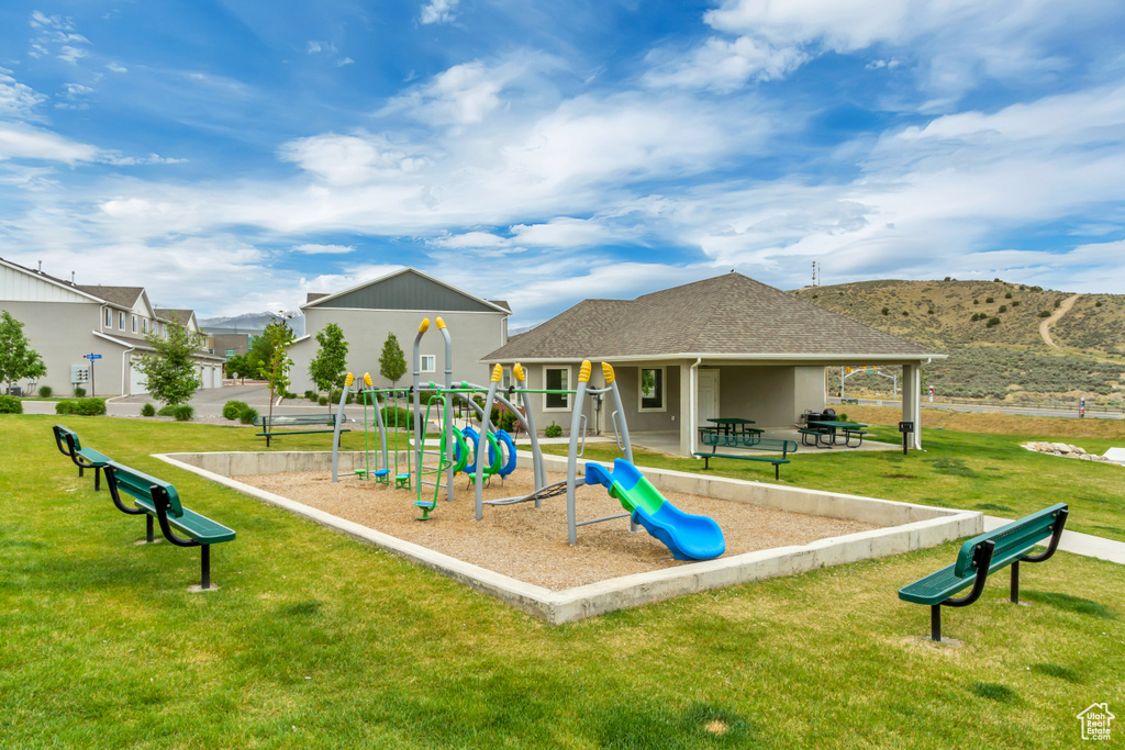 Community play area with a lawn and a mountain view