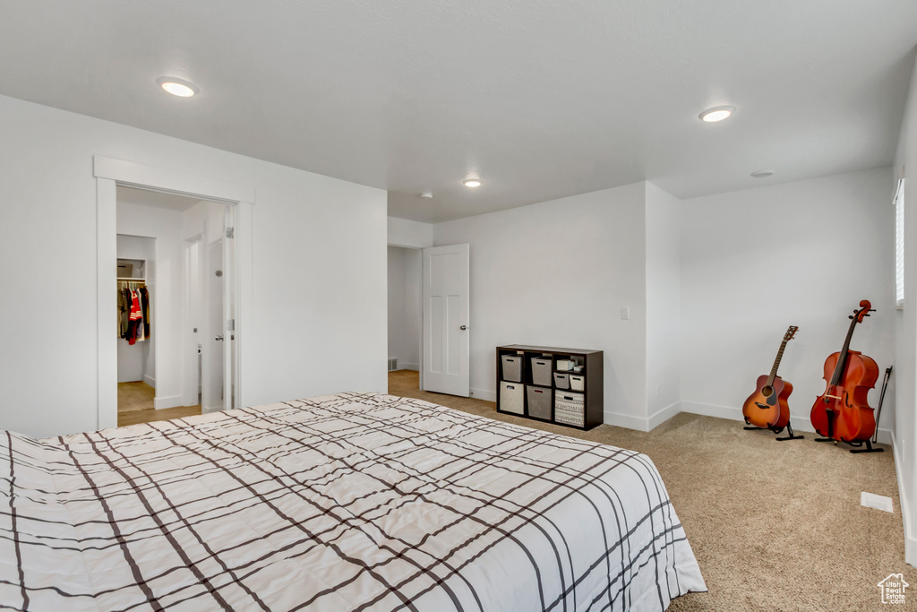Bedroom featuring recessed lighting, light carpet, and baseboards
