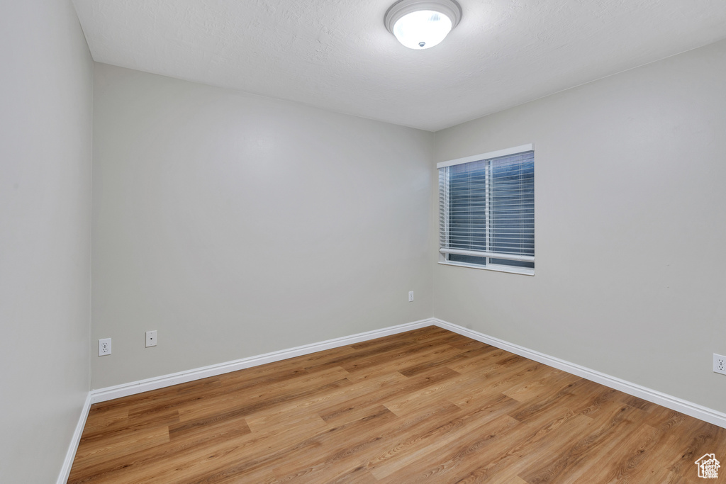 Spare room with light wood-style flooring and baseboards