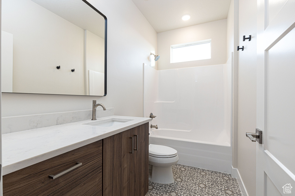 Bathroom with toilet, vanity, shower / tub combination, tile patterned floors, and recessed lighting