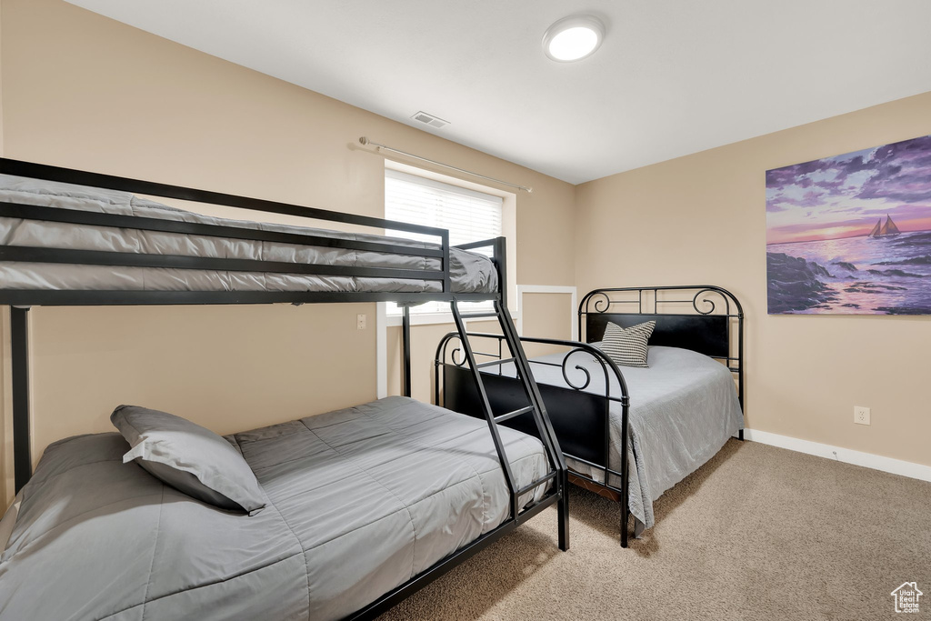 Carpeted bedroom featuring baseboards