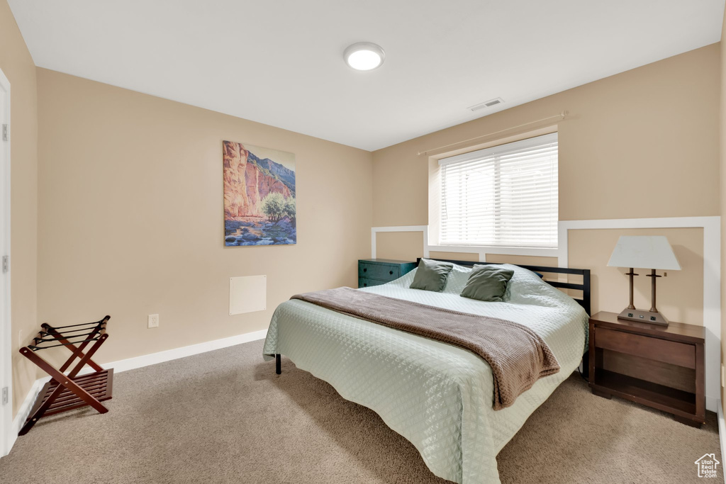 Carpeted bedroom featuring baseboards