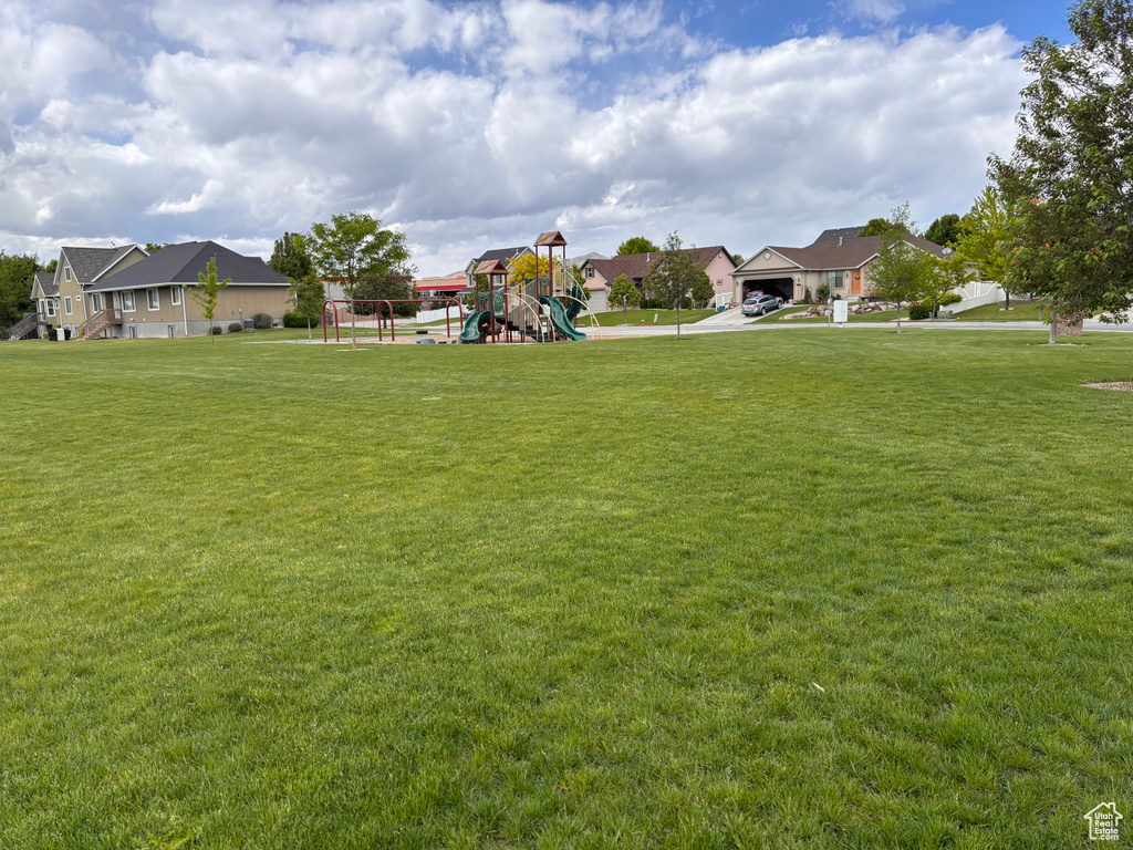 View of green lawn featuring a residential view