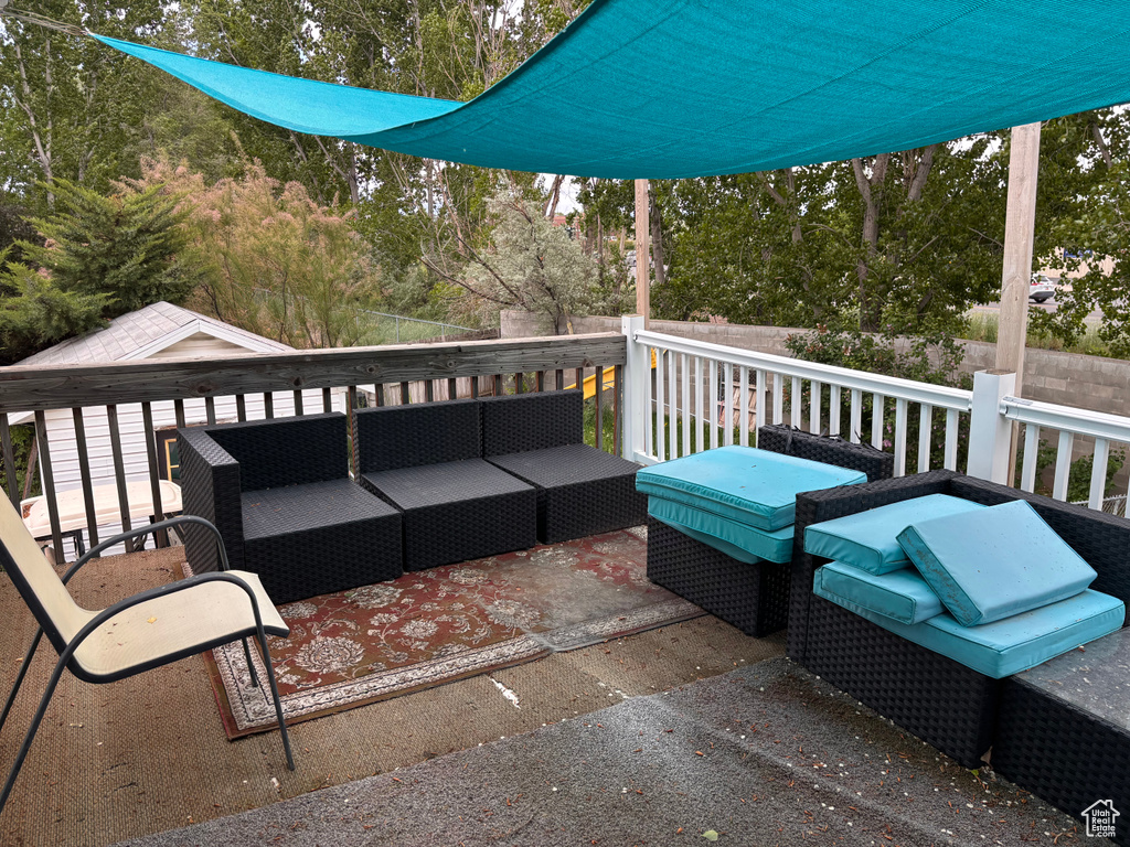 Wooden deck featuring outdoor lounge area and view of scattered trees