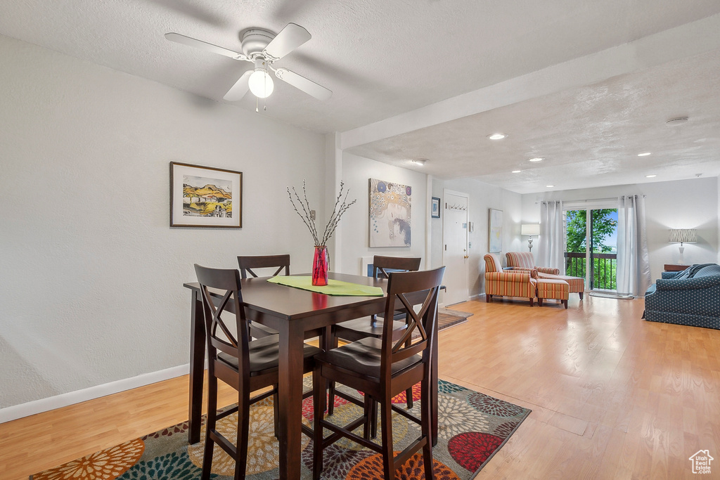 Dining area with wood finished floors, baseboards, a textured ceiling, recessed lighting, and ceiling fan