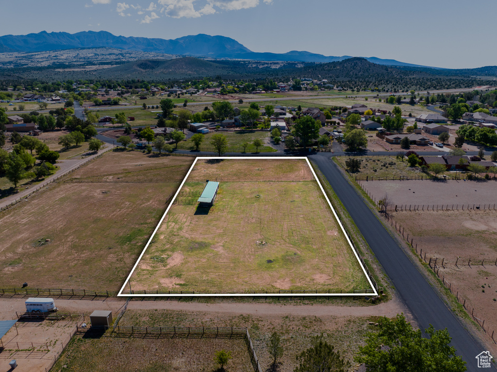 Aerial overview of property's location with property parcel outlined and mountains