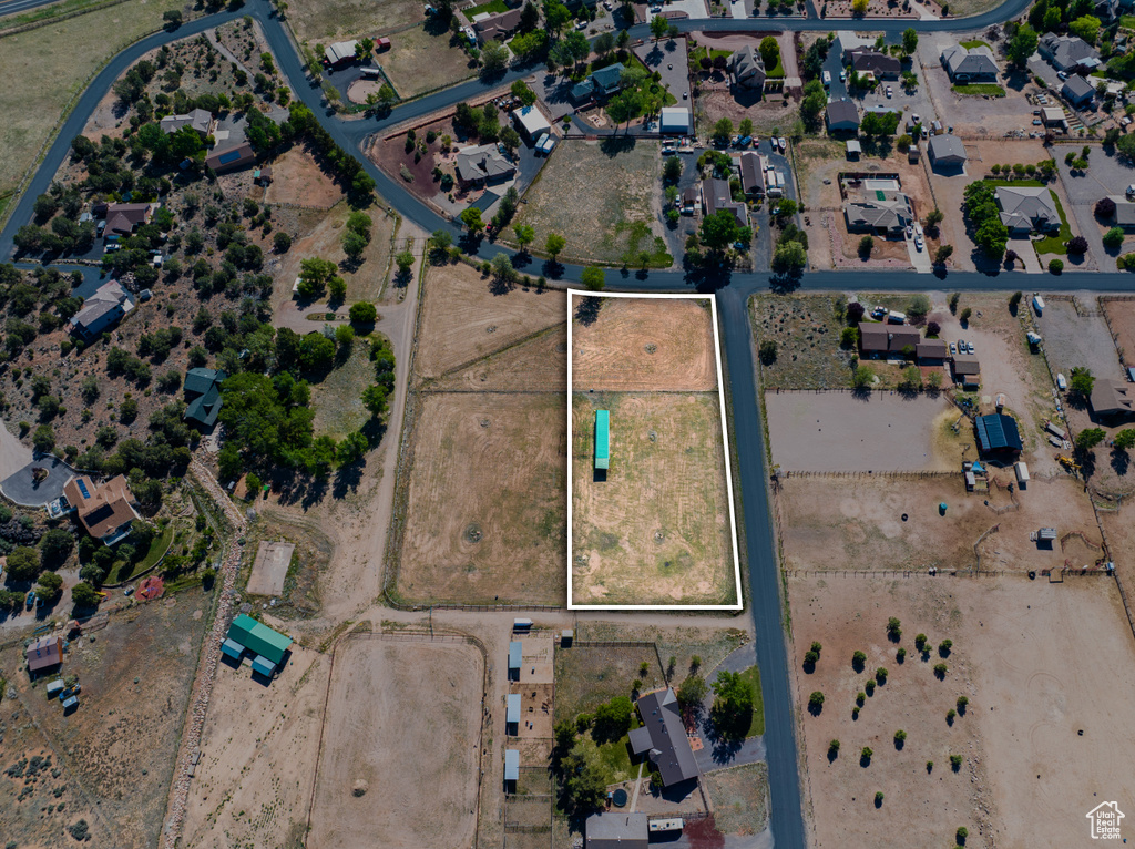 Aerial view of property and surrounding area featuring property boundaries highlighted and nearby suburban area