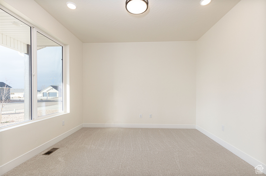 Unfurnished room with light colored carpet, baseboards, and recessed lighting