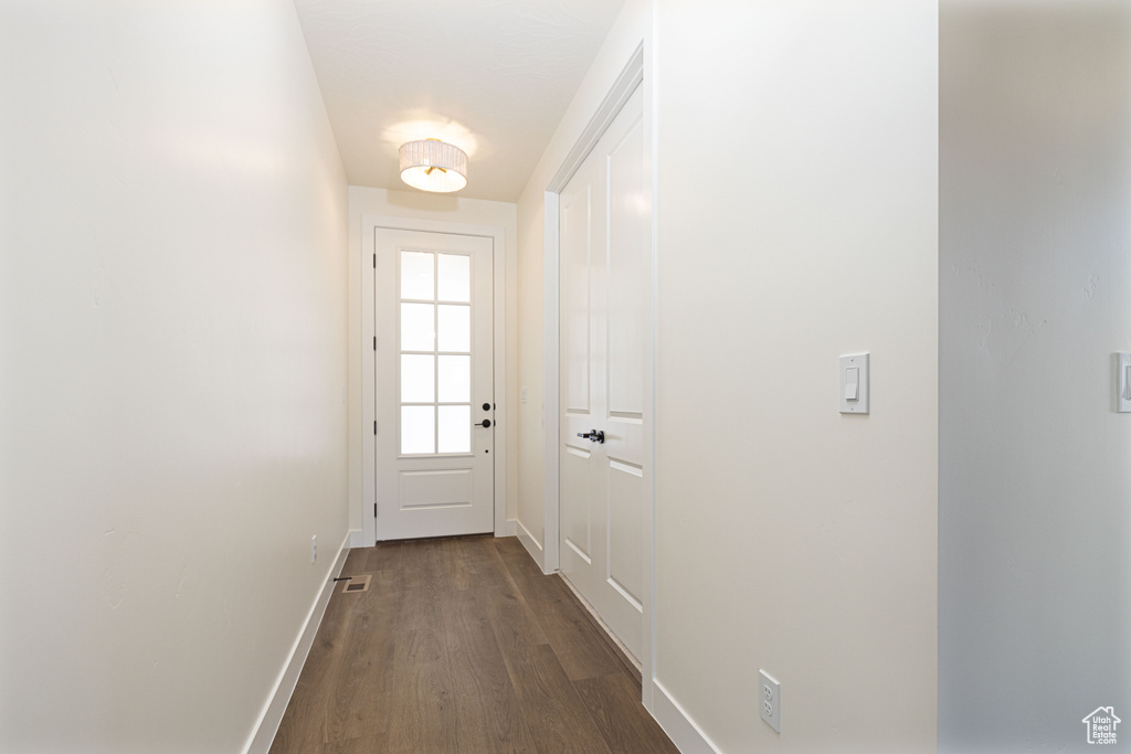 Entryway featuring dark wood-style flooring and baseboards
