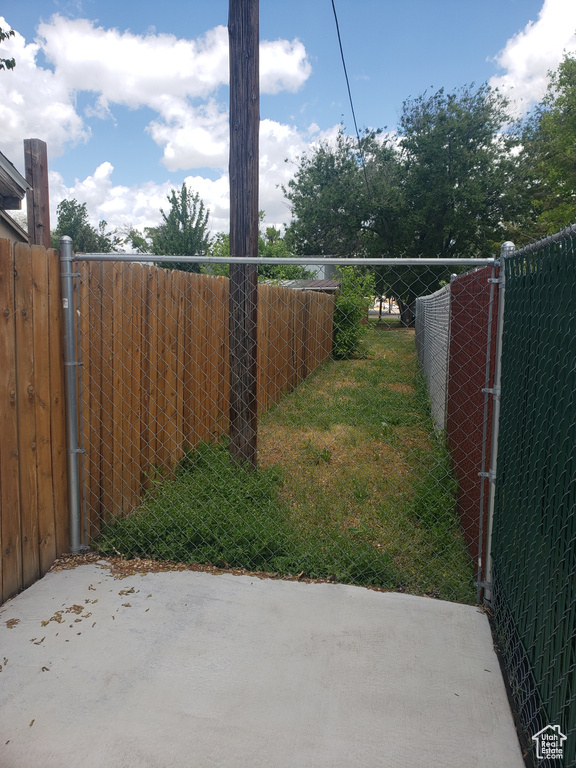 Gate featuring a patio and fence