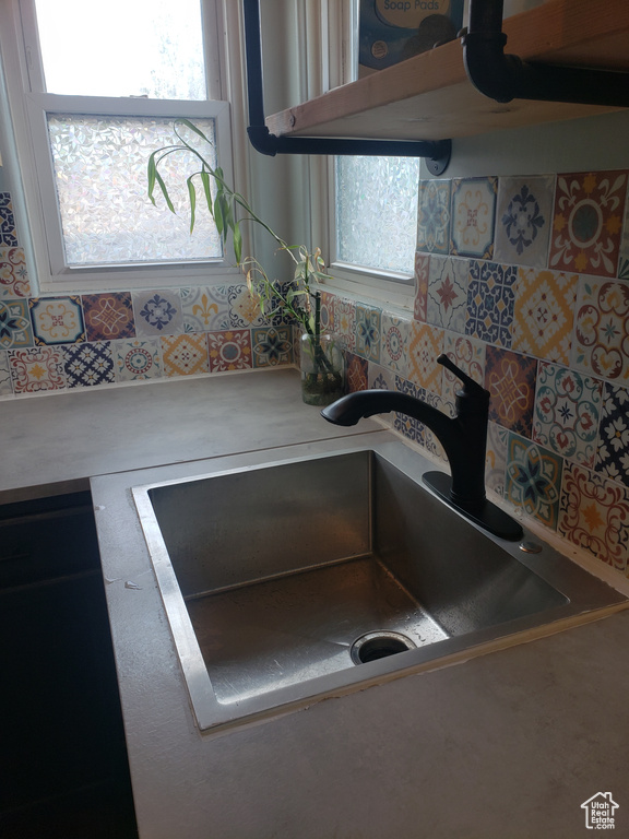 Kitchen view of a sink and light countertops