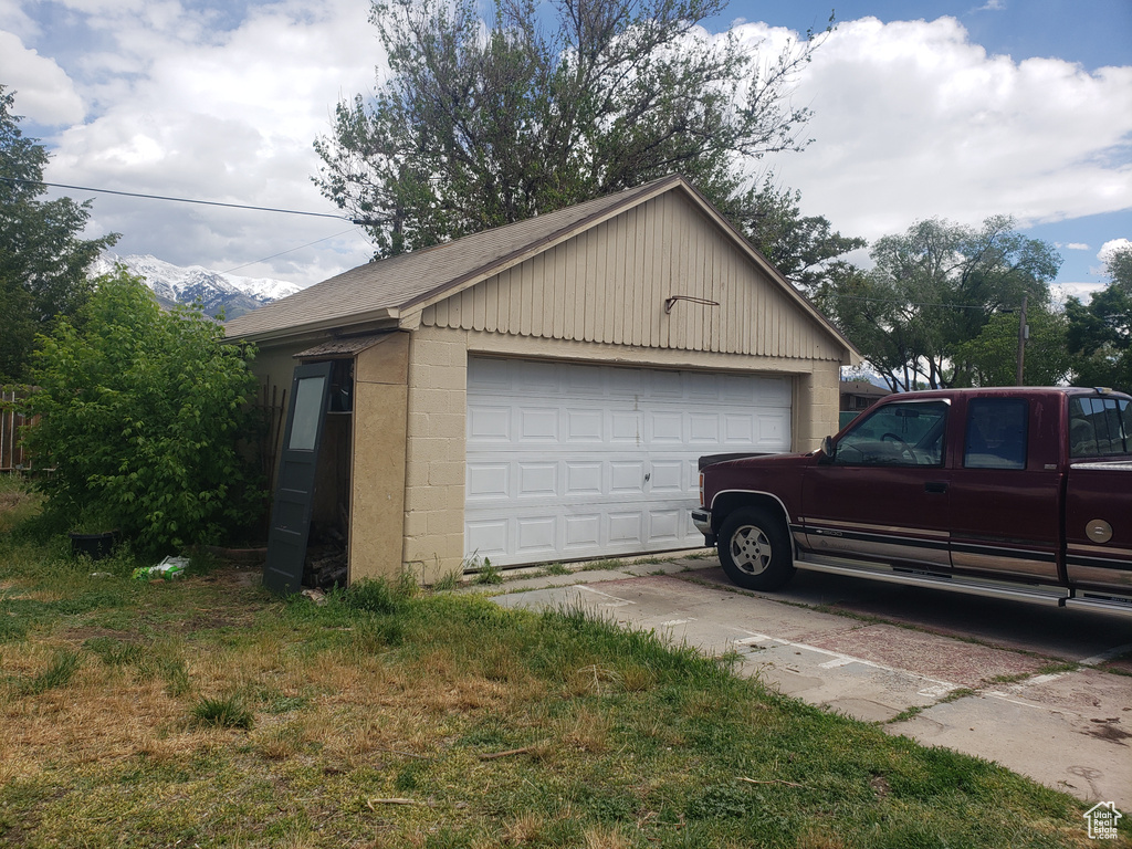 Detached garage featuring a mountain view
