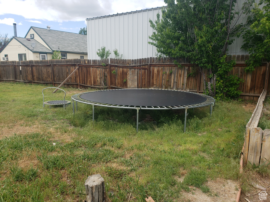 View of yard with a trampoline