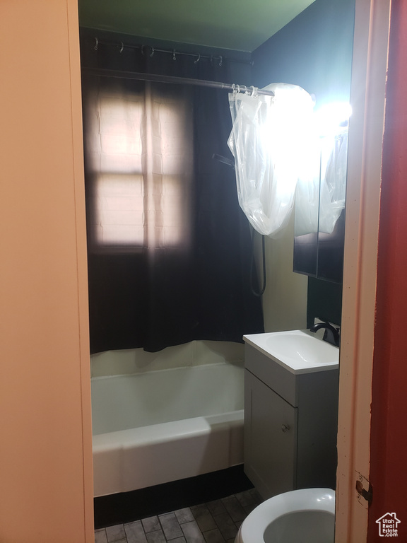 Full bath featuring toilet, vanity, and shower / bath combination