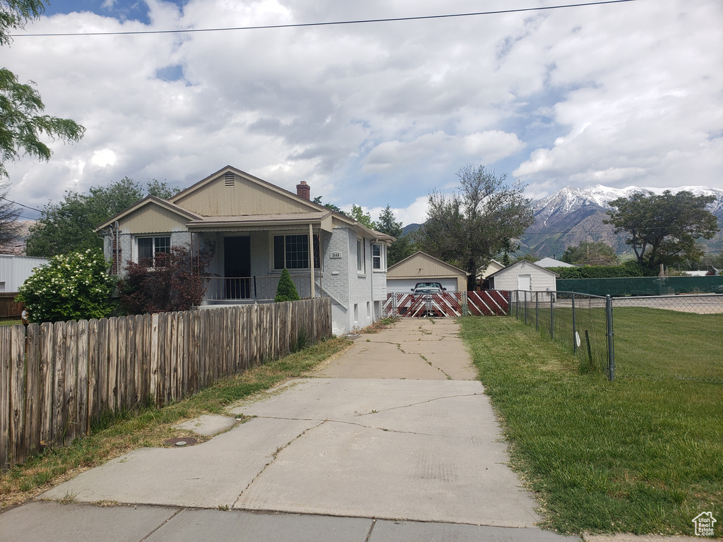 View of front of home with a garage and a chimney