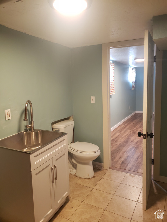 Bathroom with tile patterned flooring, toilet, and vanity