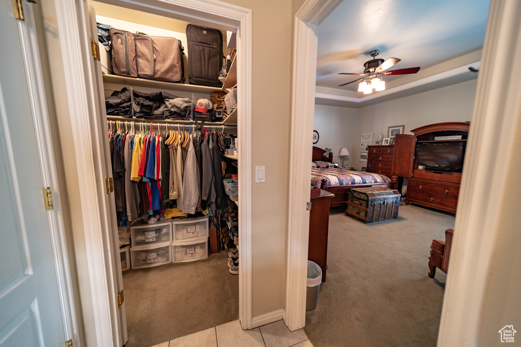 Carpeted bedroom with a closet and tile patterned floors