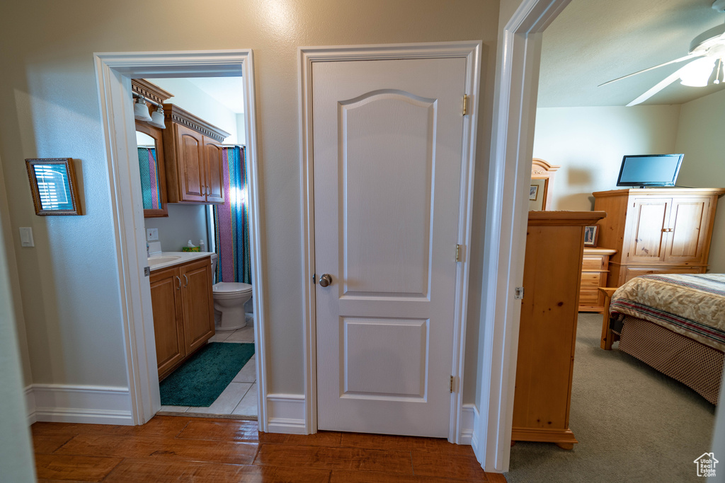Corridor featuring baseboards and wood finished floors