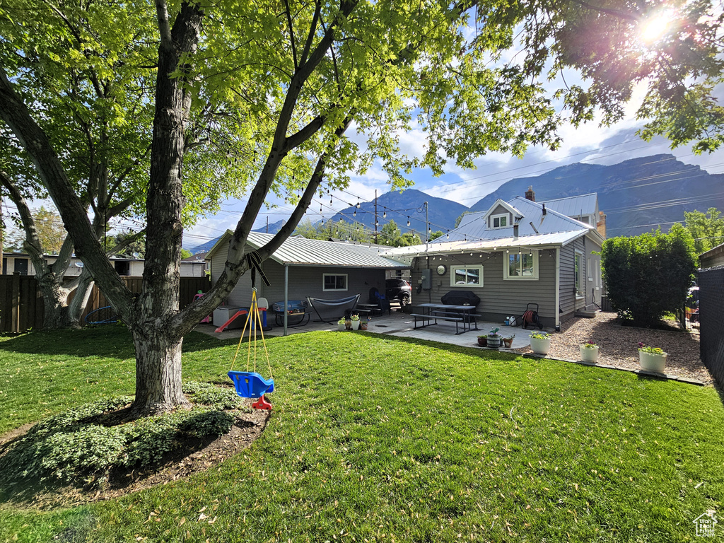 Back of property with a patio, metal roof, and a mountain view