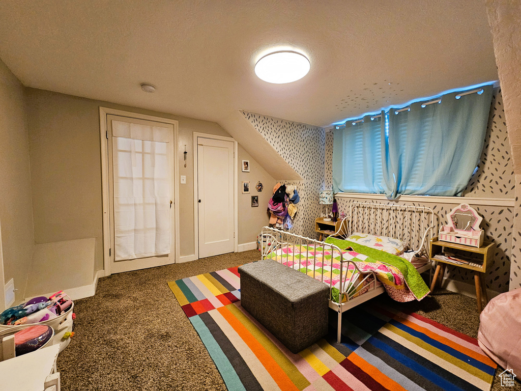 Bedroom featuring carpet flooring and baseboards