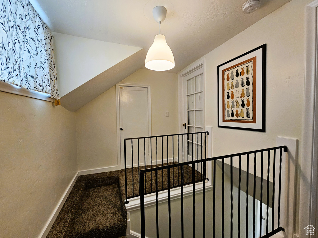 Stairs featuring baseboards and carpet flooring