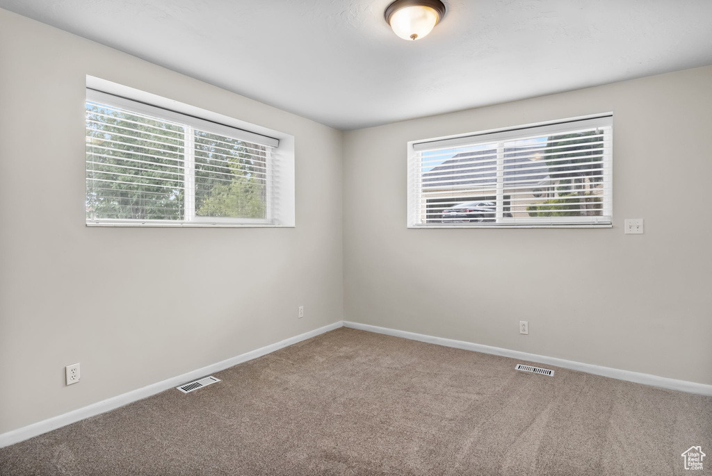 Unfurnished room with carpet and baseboards